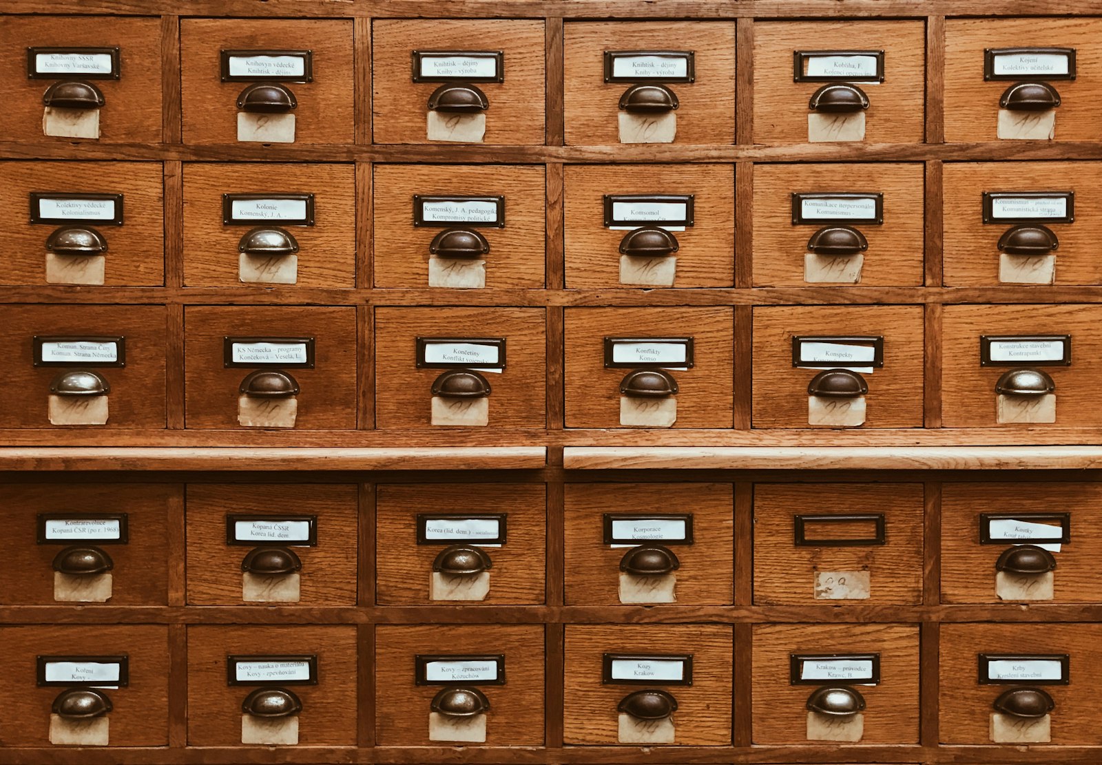 Rows of wooden card-catalogue drawers holding filed personal records