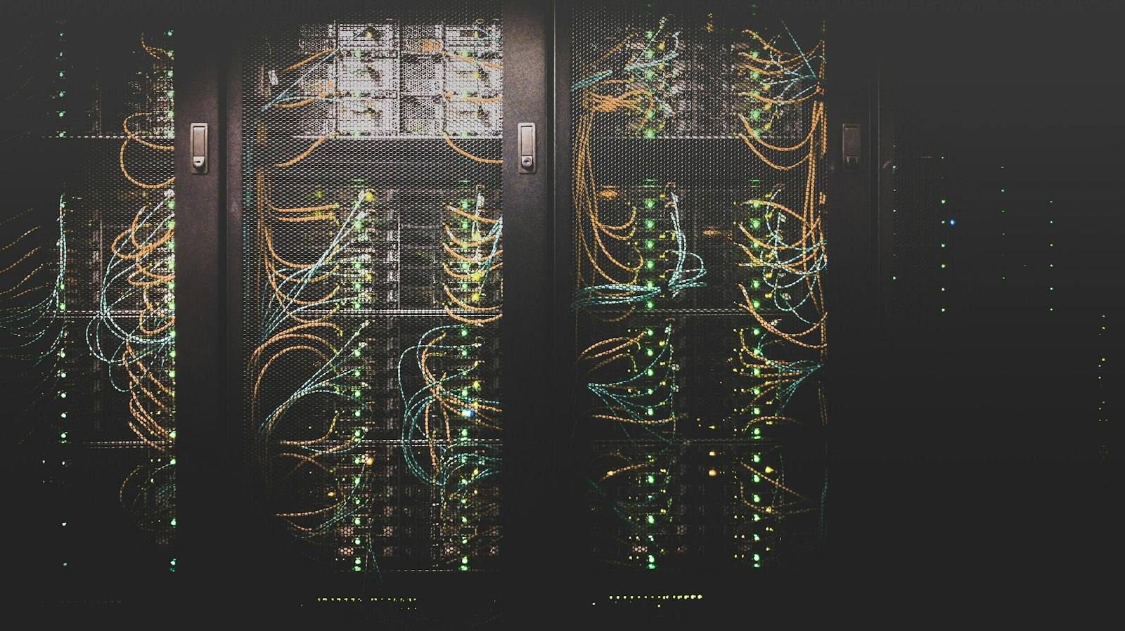 Rows of patch panels and cabling in a darkened network room